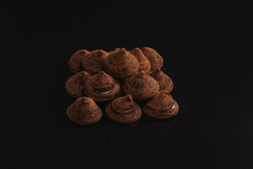 Chocolate truffles on a black background.