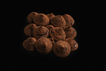 Chocolate truffles on a black background.