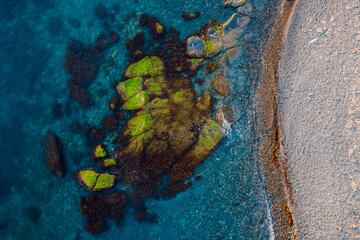 Aerial view of ocean with stones and coastline