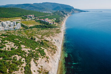 Coastline with sea and cliff with trees on coastline. Aerial view