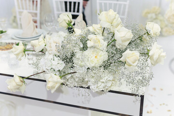 Wedding floral decor in white at a banquet in a restaurant.