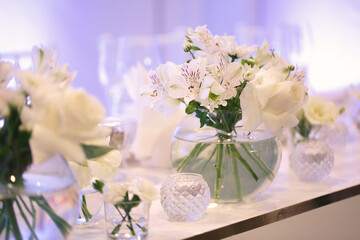 Table setting at a luxury wedding reception. Beautiful flowers on the table.