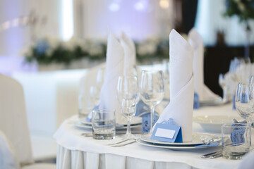 Beautiful setting of the wedding banquet table in the restaurant with the name of the guest.