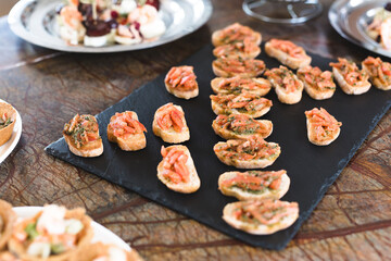 Bruschetta, snacks on a tray on the buffet table.