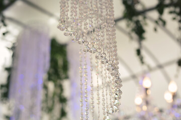 Beautiful luxurious romantic decor for a wedding celebration.  The arch is decorated with draped...