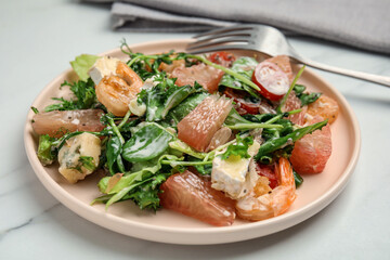 Delicious pomelo salad with shrimps served on white table, closeup