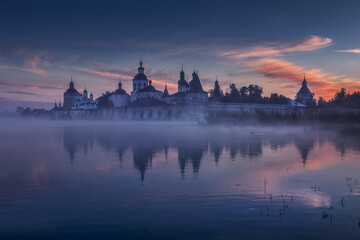Attractive and unique view of the Kirillo-Belozersky Orthodox monastery. Misty and quiet morning on the lake. Country landscape. Dawn. Russian northern style. Vologda. Kirillov. Russia.