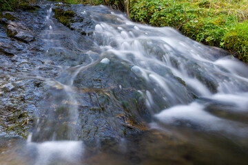 Small mountain stream flowing downhill with long exposure motion blur effect (Untertauern, Austria)