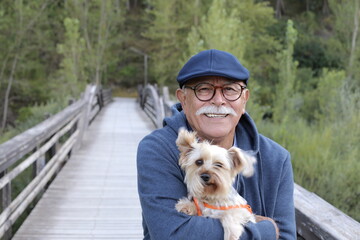 Tender senior man and his small dog