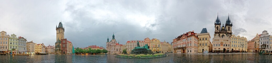 Panorama view of Old Town Square in Prague, Czech Republic with landmarks of Old Town Hall, Astronomical Clock Tower, Gothic Church of Our Lady before Tyn, Jan Hus Memorial & the St. Nicholas Church