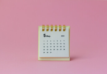 Calendar for May 2022 on a pink background.