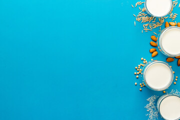 Variety of non dairy vegan milk with ingredients - almonds soy rice and oats