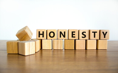 Honesty symbol. The concept word Honesty on wooden cubes. Beautiful wooden table, white background,...