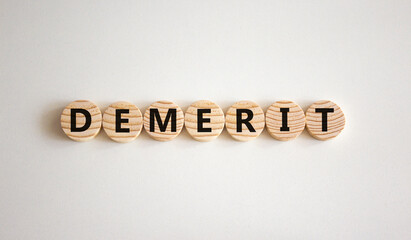 Demerit symbol. The concept word Demerit on wooden circles. Beautiful white background, copy space. Business and demerit concept.