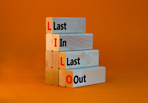 LILO Last In Last Out Symbol. Concept Words LILO Last In Last Out On Wooden Blocks. Beautiful Orange Table, Orange Background. Business And LILO Last In And Out Concept. Copy Space.