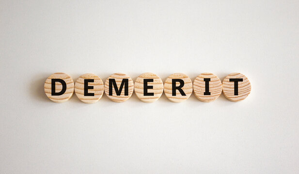 Demerit symbol. The concept word Demerit on wooden circles. Beautiful white background, copy space. Business and demerit concept.