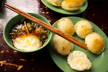 Famous authentic local delicacy of Da lat in Vietnam called Banh can (mini pancake) which is usually paired with meatball soup or banh can nha chung