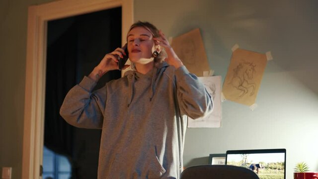 Positive woman talking on phone in the room at home