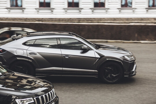 Kiev, Ukraine - June 12, 2021: Black luxury super SUV Lamborghini Urus Topcar Design in motion. Lamborghini Urus SSUV on the road. Tuned car
