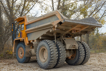 Obraz premium Large mining dump truck. Transport industry. Extraction of stone in an open pit