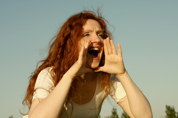 Beautiful red-haired young, woman shouting with mouth wide open. Vintage retro style.