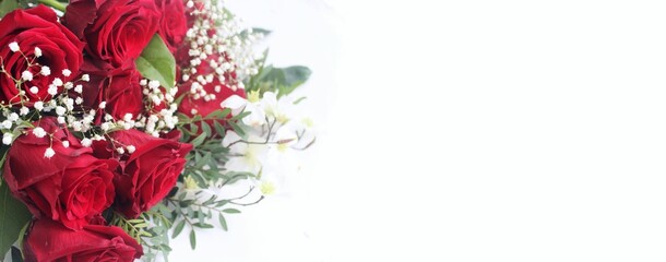 A chic festive bouquet with red roses on a white background. A bright floral arrangement. Background for a greeting card.