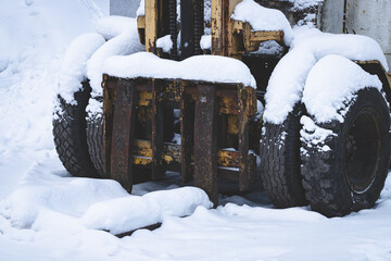 old soviet forklift covered with snow © Neils