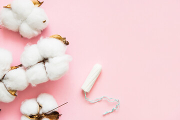 Natural cotton menstrual tampon, soft and delicate like cotton, on a pink background. Feminine hygiene items.	