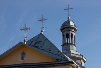 Fototapeta na wymiar Close-up of a Cross on a Christian church on blue background