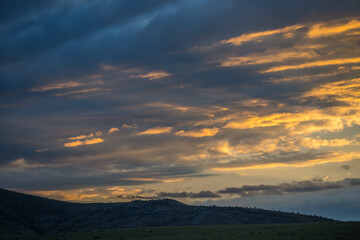 Naklejka na ściany i meble Dramatic vibrant sunset scenery in Three Forks, Montana