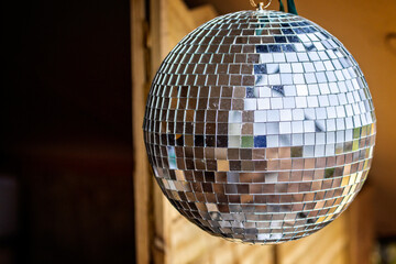 Close up of a silver reflective disco hanging outside