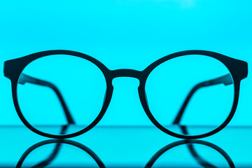Computer eyeglasses in front of a laptop, low-key image,Vector background technology in the concept of digital