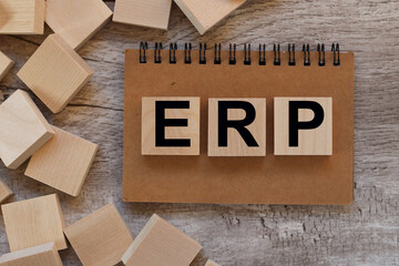 ERP. text on wood blocks on notepad on wood table