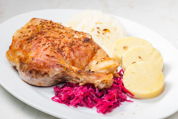roasted goose leg with red cabbage and dumplings