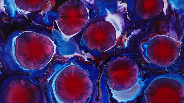 Background made with alcohol ink. Blooming magical red flowers. Ink in liquid. Circles of paint radiating over the surface. Deep ink spaces.