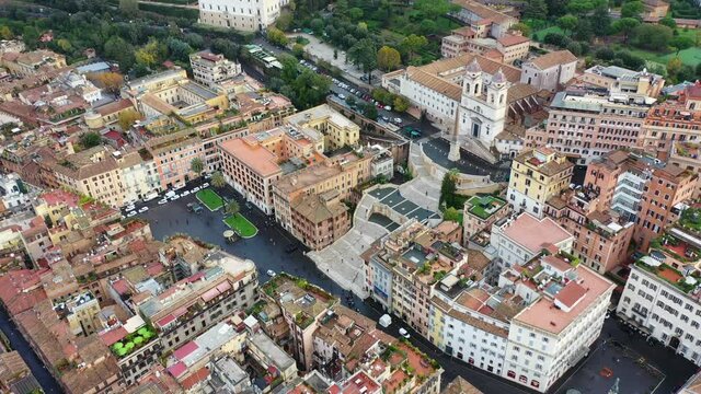 Aerial drone video of iconic Piazza di Spagna and beautiful baroque stairway a popular meeting place, Rome, Italy