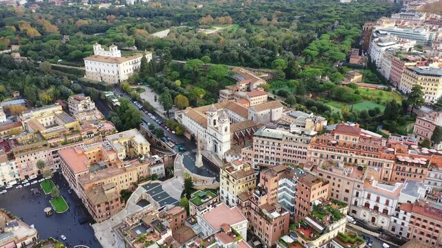 Aerial drone video of iconic Piazza di Spagna and beautiful baroque stairway a popular meeting place, Rome, Italy