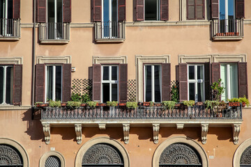 A picturesque old balcony with a painted window on the famous Piazza Navona in Rome