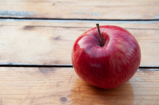 One apple on a wooden table close-up. High quality photo
