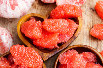 peeled red grapefruit divided into slices