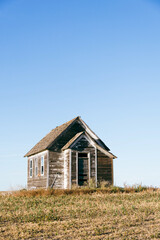 An old country church in the Great Plains during sunset with fall colors in North Dakota.