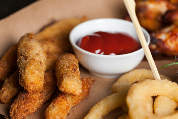 a set of dishes consisting of baked chicken wings , sets in a cafe