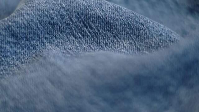 Denim Jeans Fabric Texture Close-Up. blue denim jeans material. close-up of clothing material fabric texture. footage video