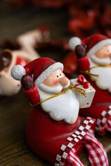 Nice Santa Claus ceramic dolls for a funny Christmas decoration in red tones.