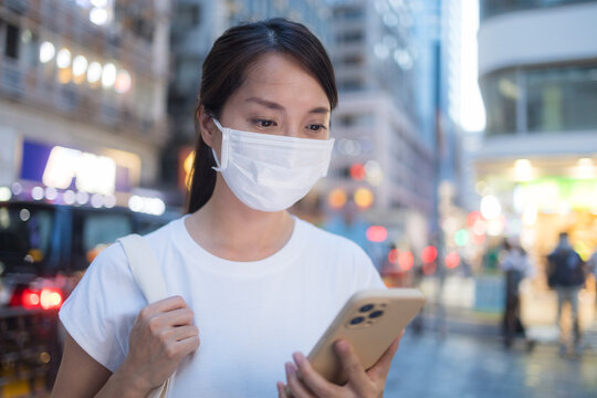 Woman wear face mask and use cellphone at outdoor