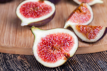 ripe purple figs on a wooden table