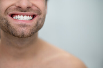 Close up picture of a man showing his teeth
