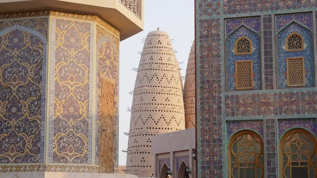 Blue mosque of Katara village made of colorful mosaic in Doha Qatar showing Pigeon tower behind
