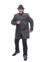 Obraz premium cheerful man in a hat and autumn coat striding forward .