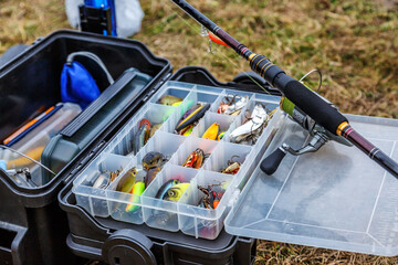 A large fisherman's tackle box fully stocked with lures and gear for fishing.fishing lures and...
